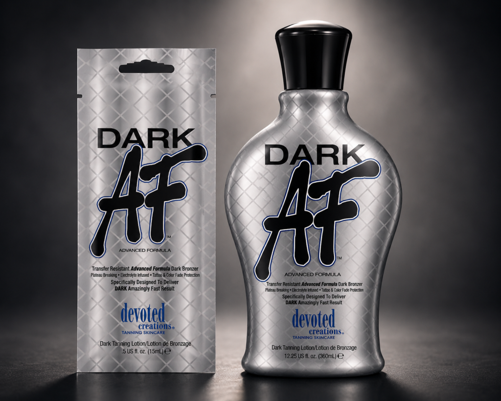 Devoted Creations Dark AF tanning lotion bottle with matching sachet on soft dark gradient background